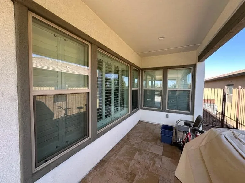 Tall windows under a covered patio with stucco walls